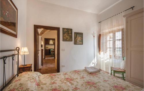 a bedroom with a bed and a window at Zafferano 1 in San Gimignano