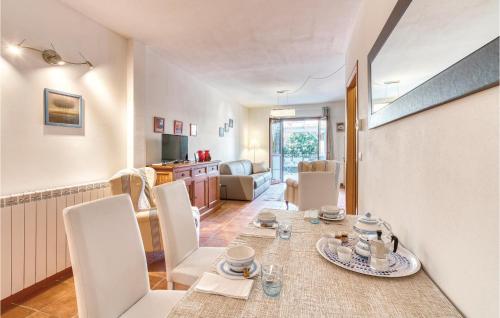 a dining room and living room with a table and chairs at Stella Marina in Puntone di Scarlino