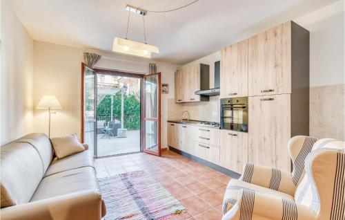 a living room with a couch and a kitchen at Stella Marina in Puntone di Scarlino