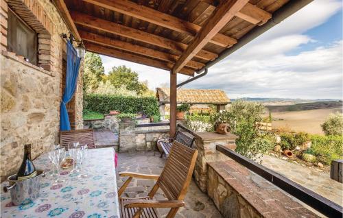 a patio with a table and chairs on a stone wall at Lovely Apartment In Prato Dera Pi in Ulignano
