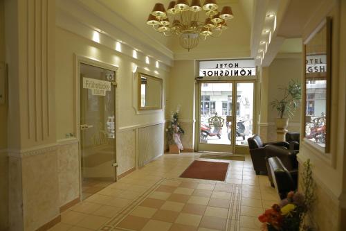 a lobby of a store with a woman walking through the door at Hotel Königshof in Mainz