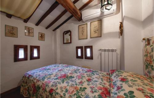 a bedroom with a bed with a floral bedspread at Villa Martelli in Capannoli