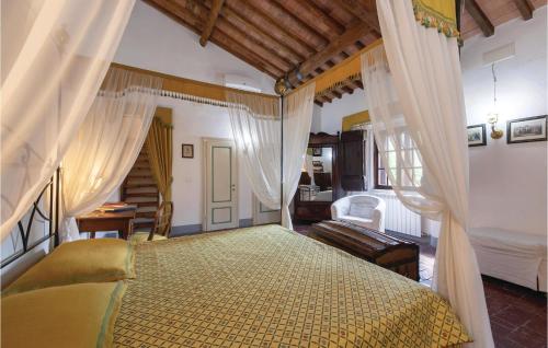 a bedroom with a canopy bed and a couch at Villa Martelli in Capannoli