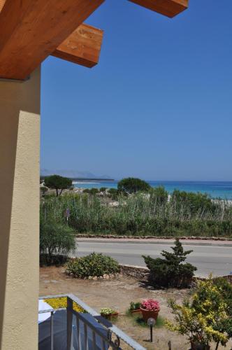 a view of the beach from a balcony of a house at Stella Marina Budoni in Budoni