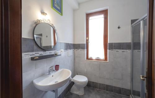 a bathroom with a sink and a toilet and a mirror at Il Quercetino in Subbiano