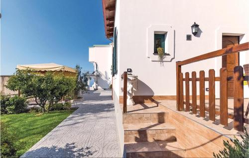 a balcony of a house with white walls and a wooden railing at Gelso Rosso in Furore