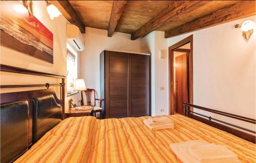 a bedroom with a bed and a wooden ceiling at Gelso Rosso in Furore