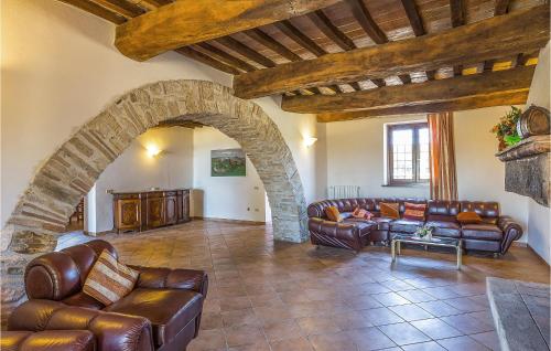 a living room with leather furniture and a stone archway at Portella in Saragano