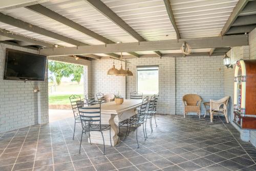 a patio with a table and chairs and a tv at "Wiltara" Estate Rural Escape for 2 to 14 Guests in Orange