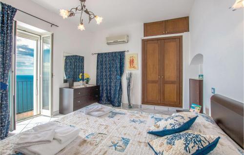 a bedroom with a bed and a large window at Gelso Blu in Furore