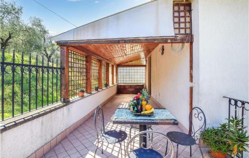a patio with a table and chairs on a balcony at 1 Bedroom Cozy Apartment In Monte Isola in Monte Isola
