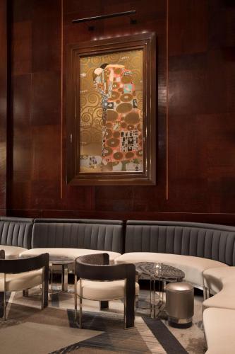 a room with a couch and tables and a painting at The Clift Royal Sonesta San Francisco in San Francisco