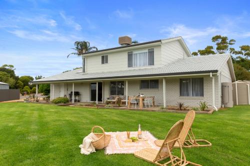 a house with a picnic table and chairs in the yard at The Arches ~ Style, location and spacious living! in McLaren Vale