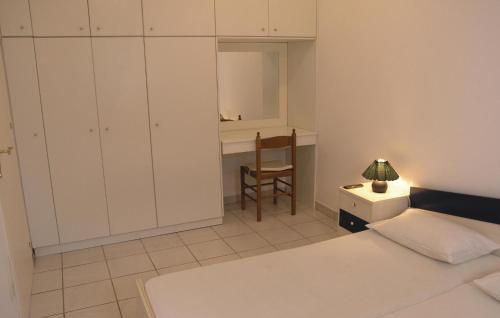 a bedroom with a bed and a desk and a chair at Soleiliosonne Haus Europa in Ermioni