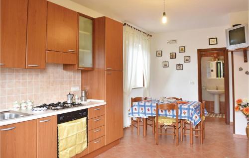 a kitchen with a table and chairs and a kitchen with a sink at Casa Antonia in Castellabate