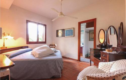 a bedroom with a bed and a dresser and a mirror at Villa Eugenia in Favazzina