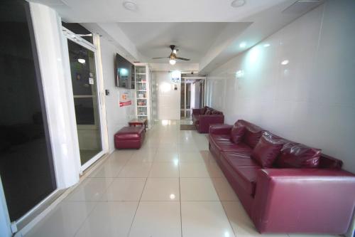 a living room with a couch and two chairs at BNB Tropical Island Aparthotel - Corales del Sur, Santo Domingo Este in Santo Domingo