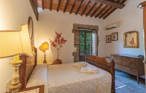 a bedroom with a bed and a table and a mirror at Cegliolo 9 in Cortona