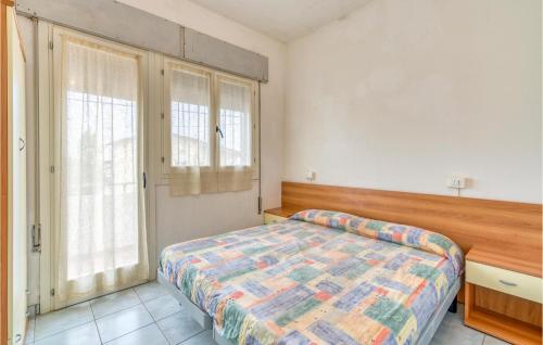 a bedroom with a bed and two large windows at Agostina 3 in Rosolina Mare