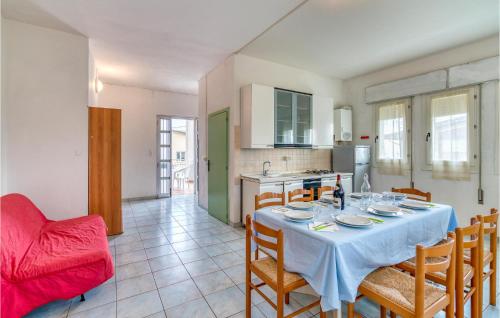 a kitchen and dining room with a table and chairs at Agostina 3 in Rosolina Mare