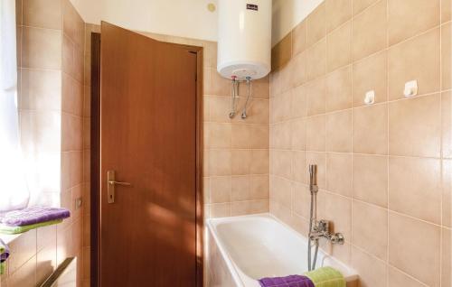 a bathroom with a bath tub and a sink at Over The Blue in Germignaga