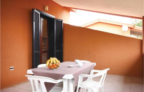 a table with a bowl of bananas on it at Beautiful Apartment In Costa Rei -Ca- With Wifi in Monte Nai