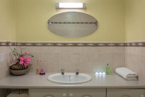 a bathroom with a sink and a mirror at Killarney Self-Catering - Haven Suites in Killarney