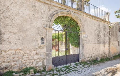 an entrance to a stone building with a black gate at Casa Pirato in Modica