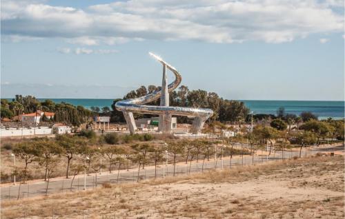 a slide at the beach with the ocean in the background at Cozy Apartment In Oropesa Del Mar in Oropesa del Mar