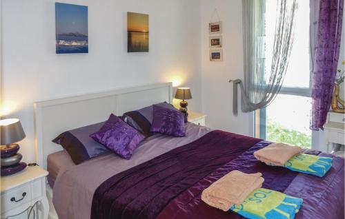 a bedroom with a bed with purple sheets and a window at Amazing Apartment In Collioure With 2 Bedrooms And Internet in Collioure