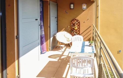 a balcony with two chairs and a table on a porch at Amazing Apartment In Collioure in Collioure