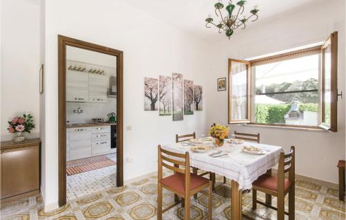 a dining room with a table and chairs and a mirror at Villa Silvana in Porto Clementino