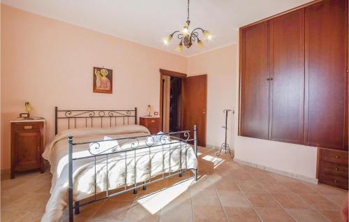 a bedroom with a bed and a wooden cabinet at Villa Aquaro in Ogliastro Cilento