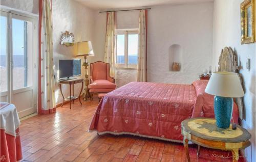 a bedroom with a bed and a table with a lamp at Villa Antica in Stalettì
