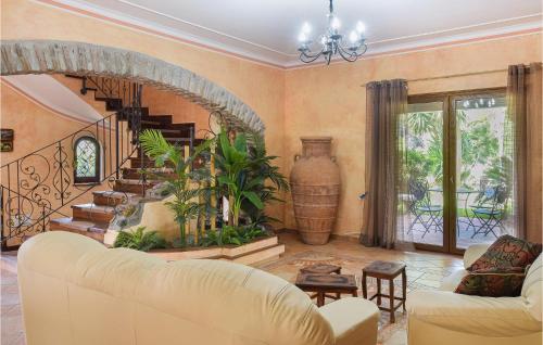 a living room with a couch and a staircase at Stunning Home In Saline Ioniche in Saline Joniche
