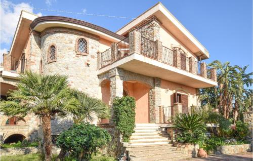 a large house with a balcony on top of it at Stunning Home In Saline Ioniche in Saline Joniche