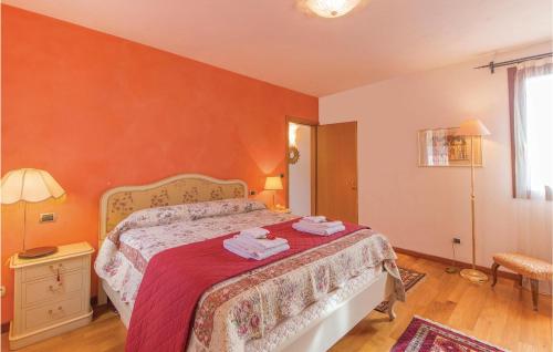 a bedroom with a bed with a red wall at Casa Bellavista in Teolo