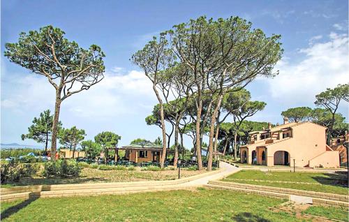 a house with trees in front of a building at Cozy Apartment In Puntone With Wifi in Puntone di Scarlino
