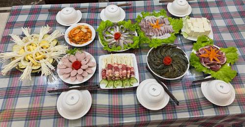 a table with a bunch of food on it at Lotus Hotel Ninh Bình in Ninh Binh