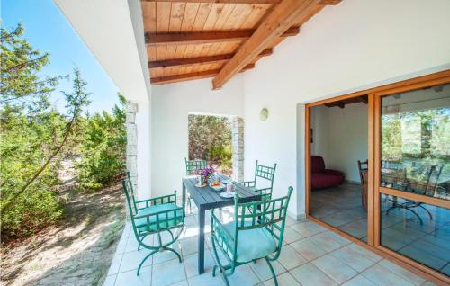 a patio with a table and chairs on it at Ginepri Bilo in Badesi
