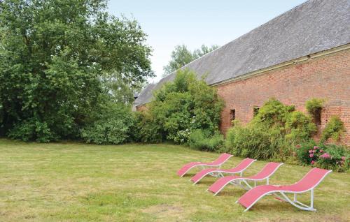 une rangée de chaises roses assises dans une cour dans l'établissement Stunning Home In Gouy Saint Andre, à Gouy-Saint-André