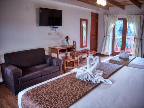a living room with a couch and a room with a couch at Sol Ollantay Boutique Hotel in Ollantaytambo