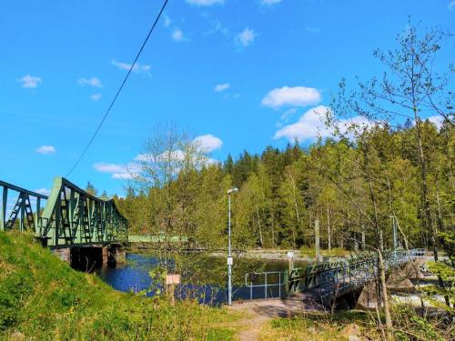 a bridge over a river with trees and a blue sky at 4 person holiday home in ED-By Traum in Ed