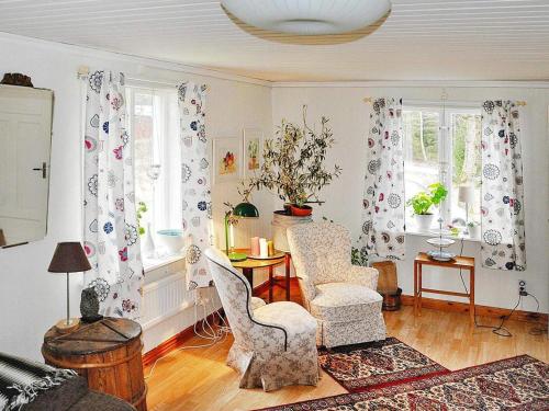 a living room with chairs and a table and windows at 4 person holiday home in ED-By Traum in Ed