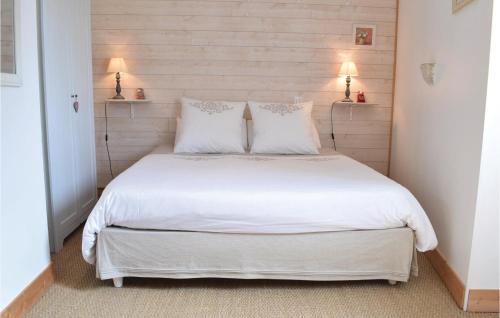 a bedroom with a bed with white sheets and pillows at Nice Home In Auxais With Wifi in Auxais