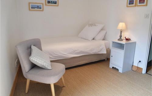 a small bedroom with a bed and a chair at Nice Home In Auxais With Wifi in Auxais