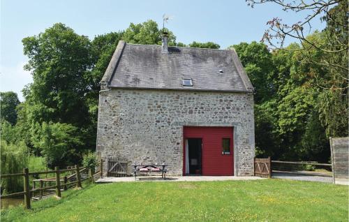 a brick building with a red door and a bench at Nice Home In Auxais With Wifi in Auxais