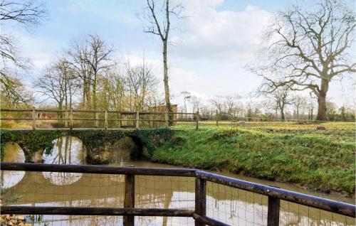 a bridge over a river in a field at Nice Home In Auxais With Wifi in Auxais