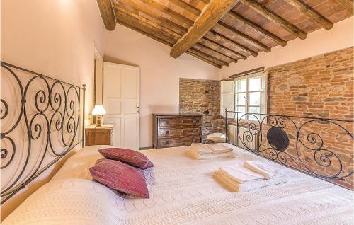 a large bed in a room with a brick wall at Paladino 3 in Montecarlo