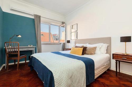 a bedroom with a bed and a desk and a bed at Claude Homes Lisbon Rato in Lisbon